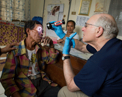 Dr. Todd Holzman examines a victim of Typhoon Haiyan at Tapaz Municipal Hospital