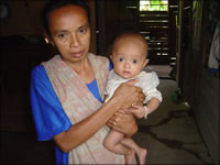 Woman holding baby facing camera