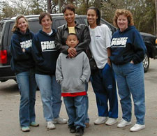 Family and Project HOPE workers standing in front of minivan