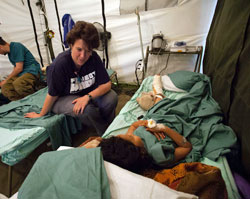 Volunteer Nurse Ann Perez helps children recovering from earthquake injuries. 