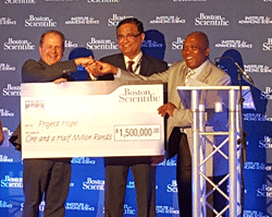 Project HOPE President and CEO Dr. Tom Kenyon (left) receives donation from Boston Scientific Corporation South Africa