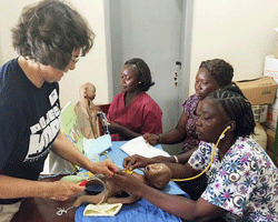 Volunteer nurse assists in healthcare training in Sierra Leone.