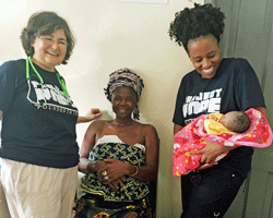 Project HOPE volunteer nurse in Sierra Leone helps deliver baby boy.