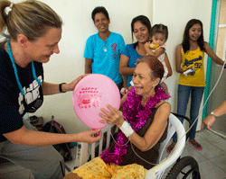 HOPE volunteer Carma Erickson-Hurt suprises Elenita with a birthday party at Tapaz District Hospital, Panay Island, the Philippines