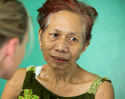 HOPE volunteer Carma Erickson-Hurt visits with cancer patient Elenita, 84, at Tapaz District Hospital 
