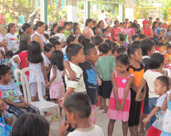 children gather in the Tapaz Civic Center for a day of renewal activities