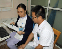 SCMC staff introducing lung function test to Dr. Feng Wei