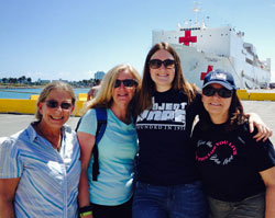 Linda Lauer, right, prepares to baord the USNS Comfort for a humanitarian mission as a Project HOPE volunteer. 