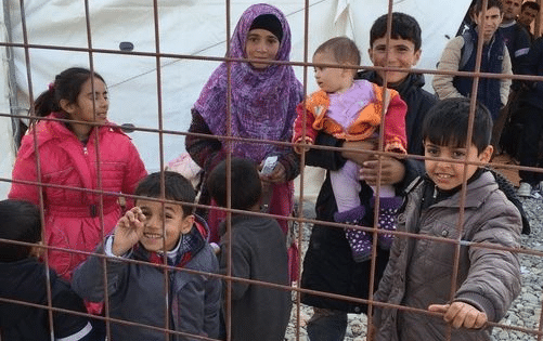 Refugee children behind a cage