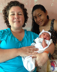 Volunteer Amy Kogut, CNM, delivers a healthy baby girl at Tapaz District Hospital