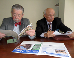 HOPE volunteer Dr. Delgado (right) reads the HOPENews from Trujillo. 