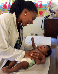 Dr. April Edwards with a young patient at the Monte Plata clinic, Dominican Republic