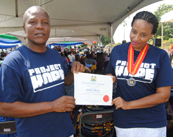 Osman Kabia, Project HOPE's In-Country Consultant in Sierra Leone, and Mariam Sow, Project HOPE's Sierra Leone Consultant, accept the silver medal on Project HOPE's behalf