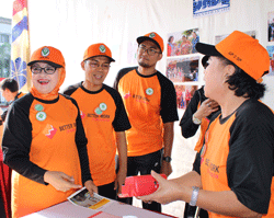 The Vice Regent of Subang District (left) after her anemia screening test at the Project HOPE HealthWorks exhibition booth