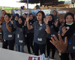Factory health volunteers giving an energetic hand washing demonstration at the Hansoll factory, Subang City, Indonesia