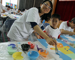 HOPE's Lisa Zhou and son participate in the Disney VoluntEARs program to create artwork for the new oncology tower at the Shanghai Children’s Medical Center. 