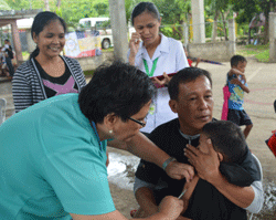 A child is vaccinated against measles in the Philippines with Project HOPE-donated product