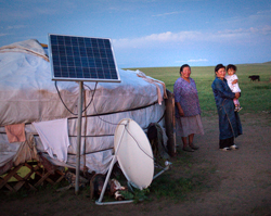 Davaa P., left, stands with her daughter and granddaughter outside of their traditional Mongolian ger home-- equipped with a solar panel and satellite dish-- near where operation Pacific Angel Mongolia has set up camp in Eastern Mongolia, July 23, 2011.