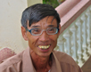 Vietnamese man shows off new glasses.