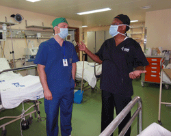 Dr. Venko Filipce meets with a surgeon at Muhimbili National Hospital