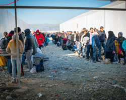 Migrants line up at the Gevgelija Transit Center on the border with Greece