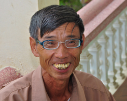 Vietnamese man shows off new glasses.