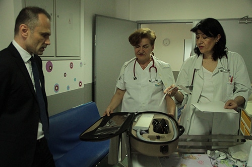 Hospital workers examining equipment
