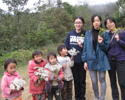 Children giving flowers to Project HOPE staff.