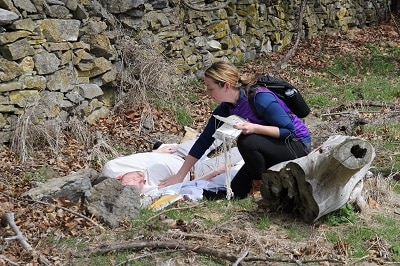 A simulation participant provides medical assistance to an injured person