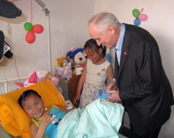 Dr. Howe visits with twins in 2008, following the massive earthquake. 