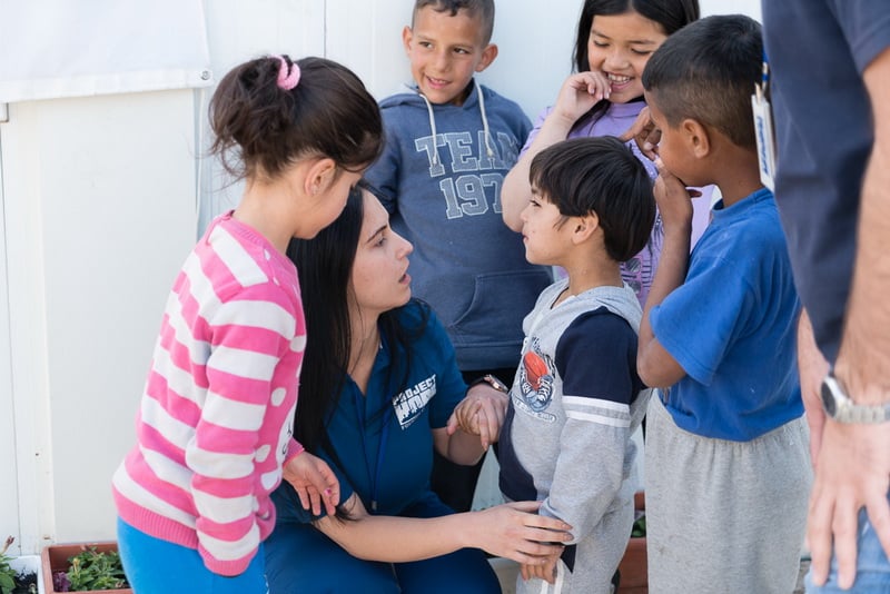 Volunteer talking to children