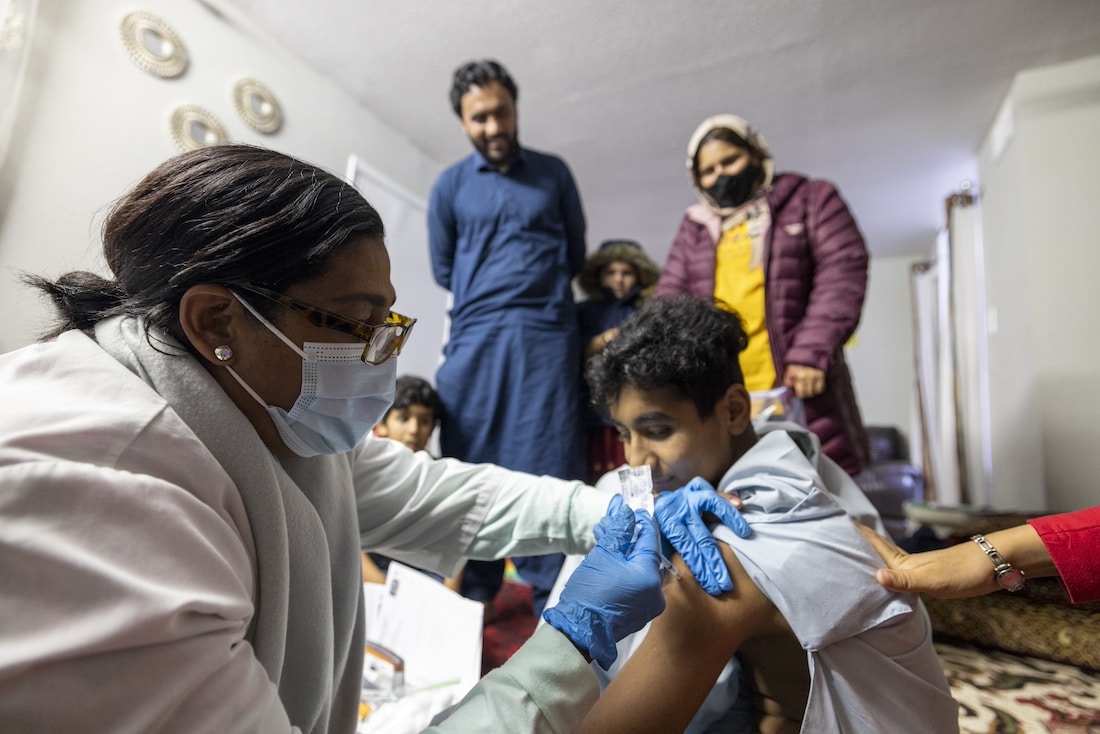 nurse vaccinating a child