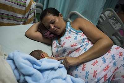 woman in hospital bed with baby