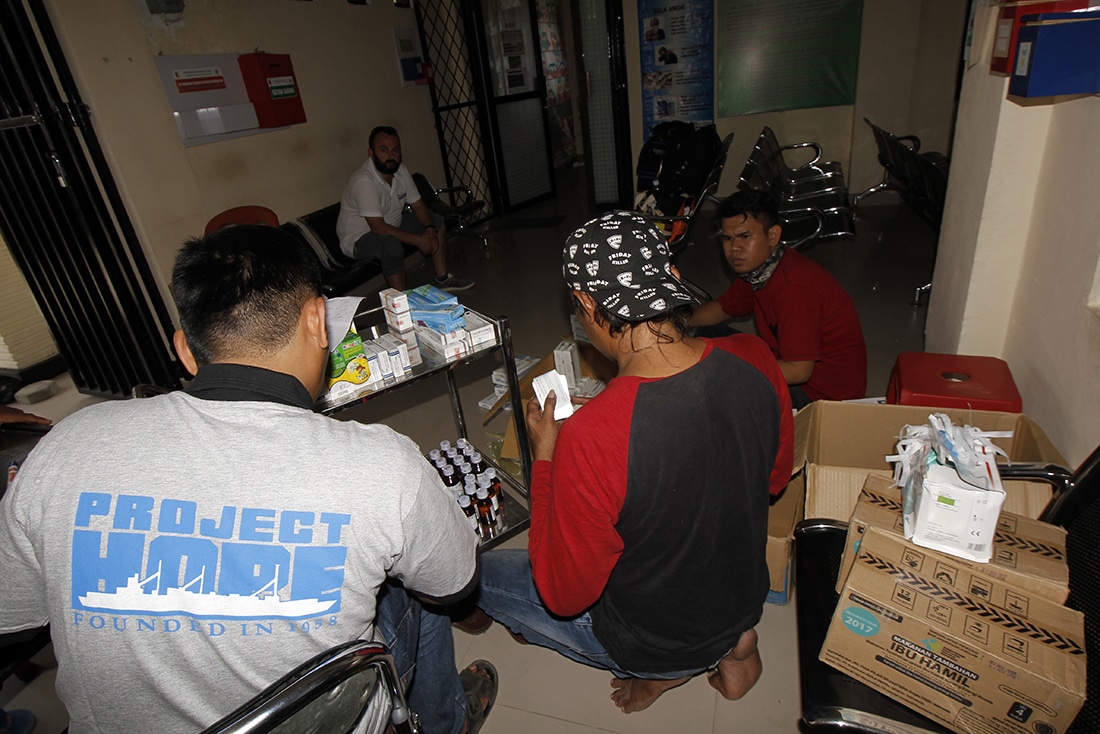 volunteers working with supplies and medicines in Indonesian clinic