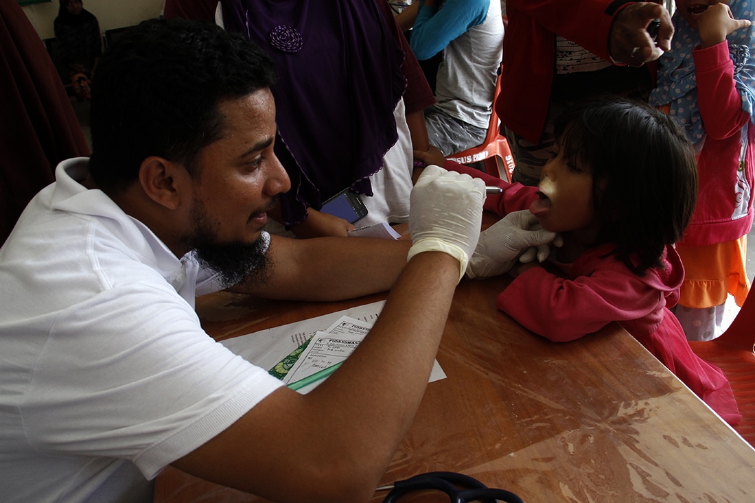 Medical volunteer treating patient little girl