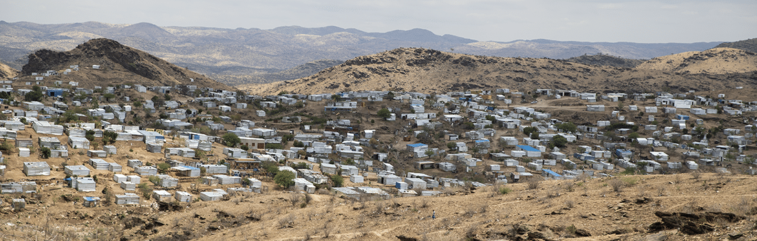 Corrugated metal housing in a landscape of hills