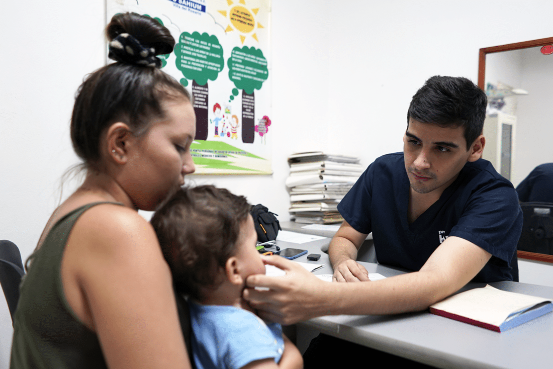 Dr. Jose examines a young patient.