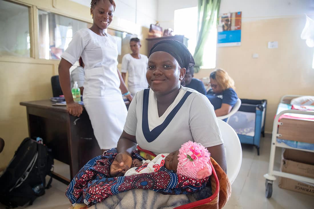 Mother holding her newborn baby in a hospital in Bo Sierra Leone.