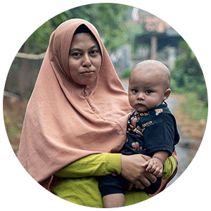 mother in Indonesia holding her child.