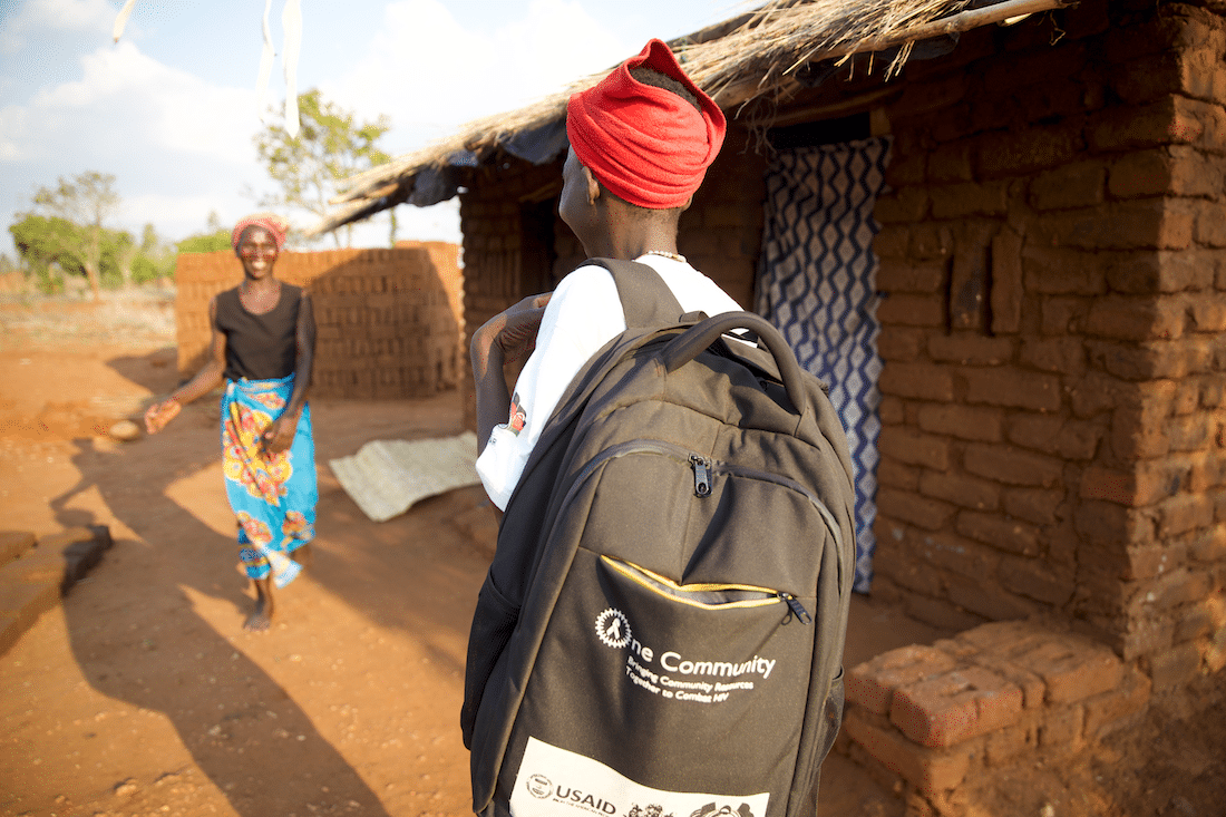 Project HOPE's Emelita carrying a backpack as she makes a home visit