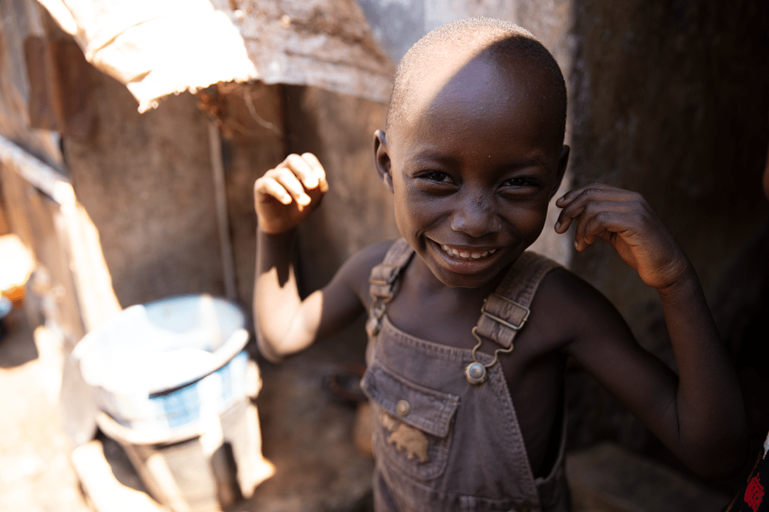 Portrait of a boy in Sierra Leone smiling at the camera