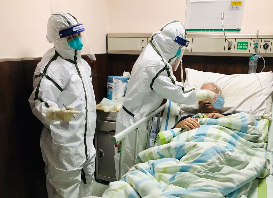 Nurses attend to a patient that tested positive for the coronavirus in a Wuhan hospital.