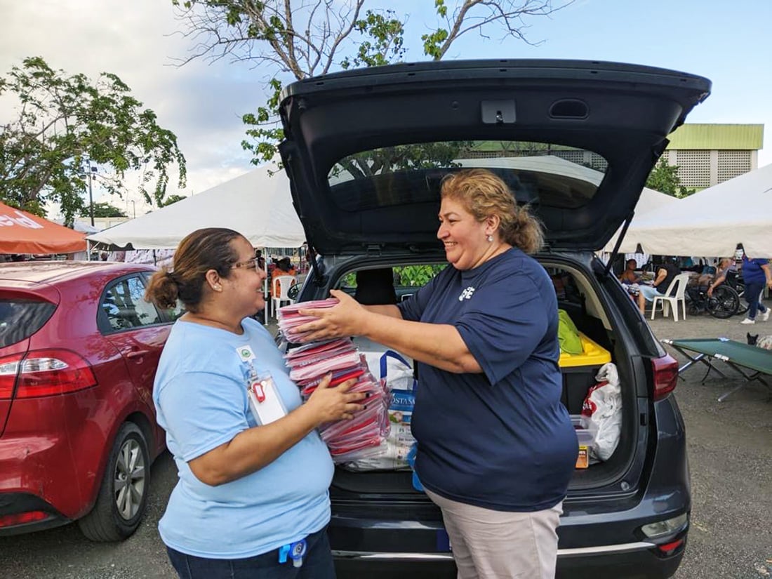 Project HOPE employees taking frio bags out of the car to distribute in Puerto Rico after the Earthquake
