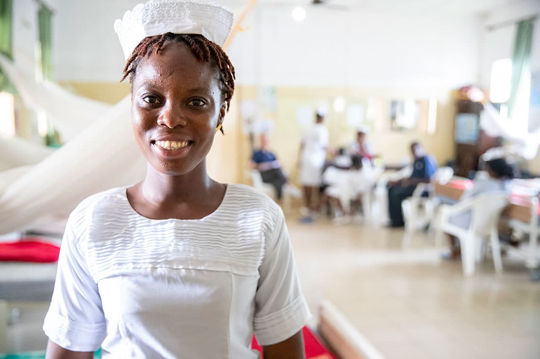 A nurse smiling in her unit at the hospital.