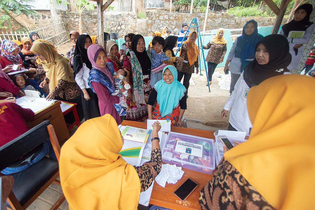Woman gather with children for a wellness check up.