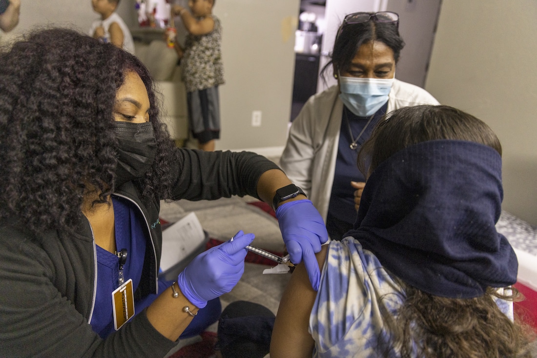 Health workers administering vaccines in Texas