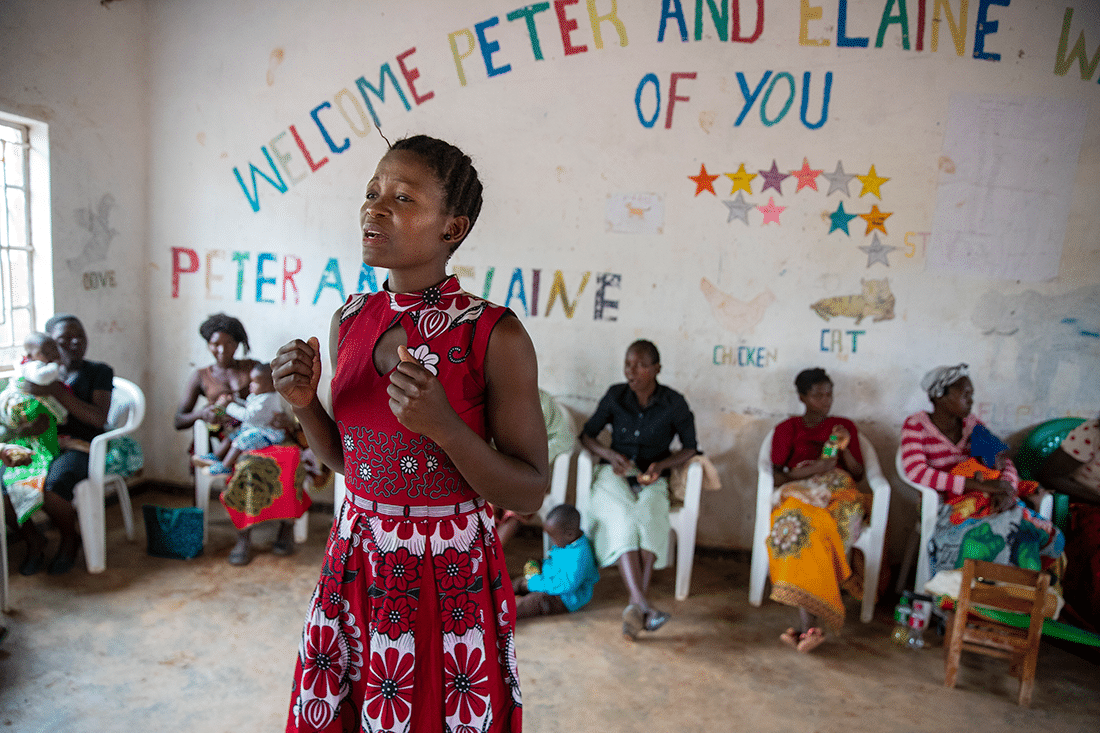 A woman in Malawi shares her story in a community group.