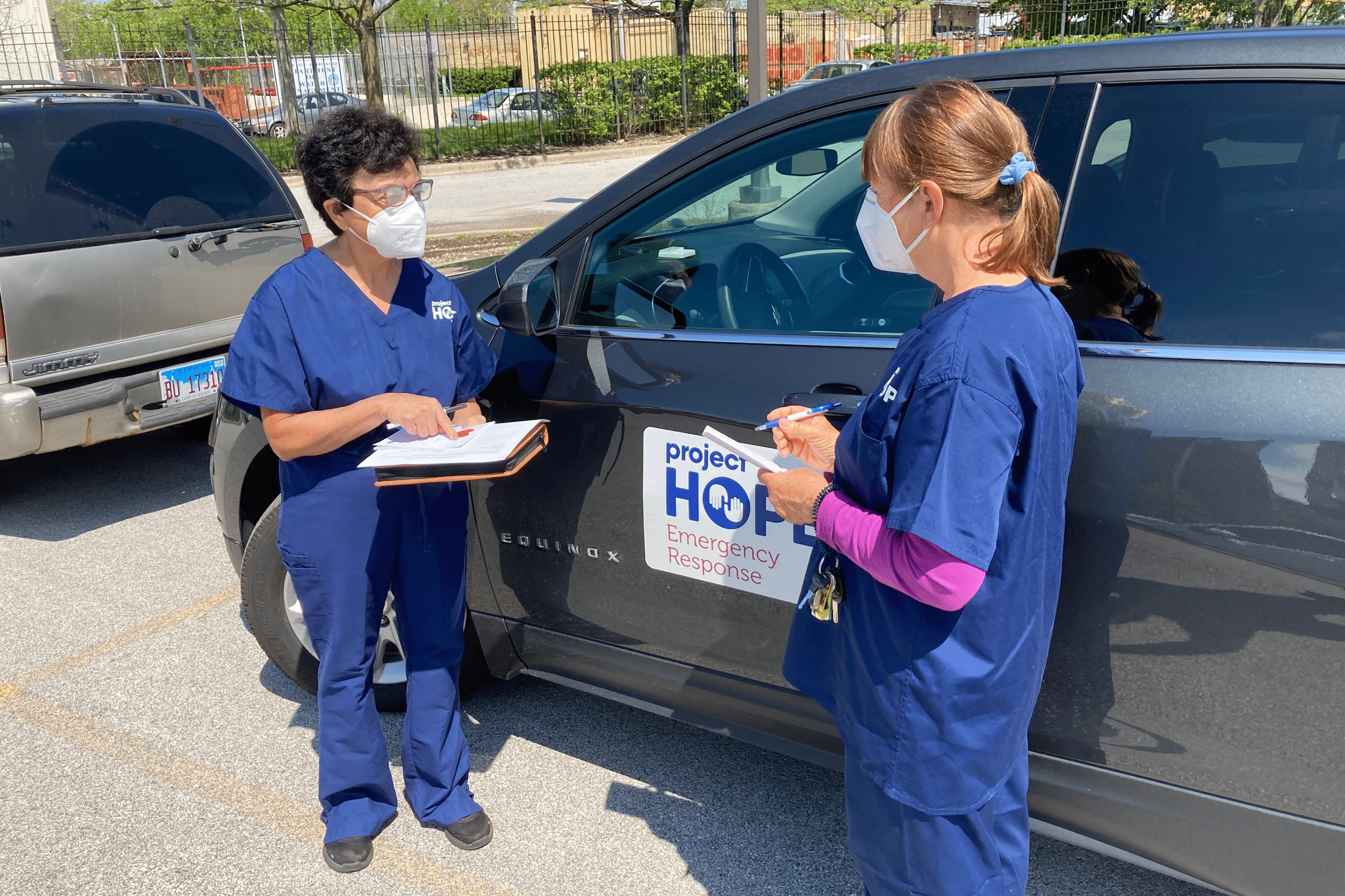 two nurses meeting outside health care facility