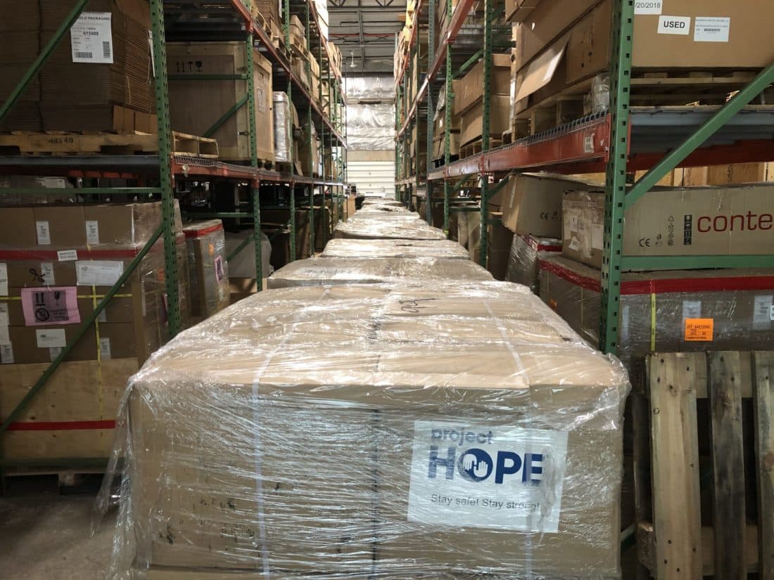 Pallets of PPE being loaded in warehouse