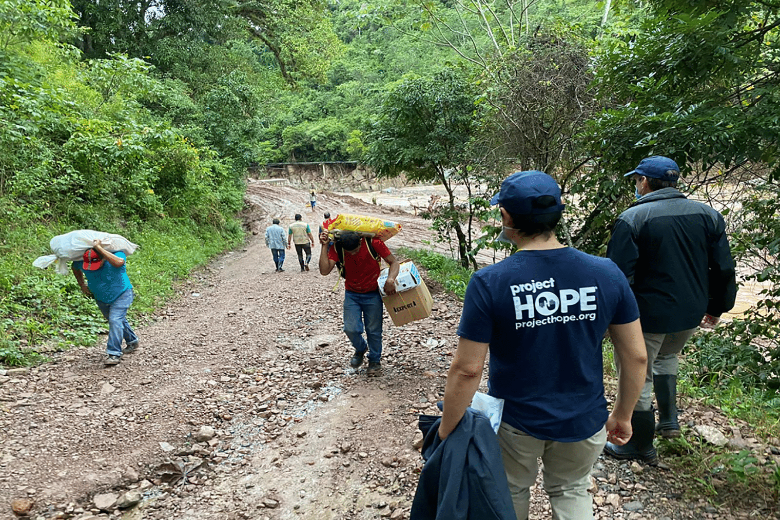 groups of men walking up and down a muddy hill